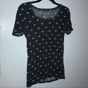 Black shirt with puppies designed on it.